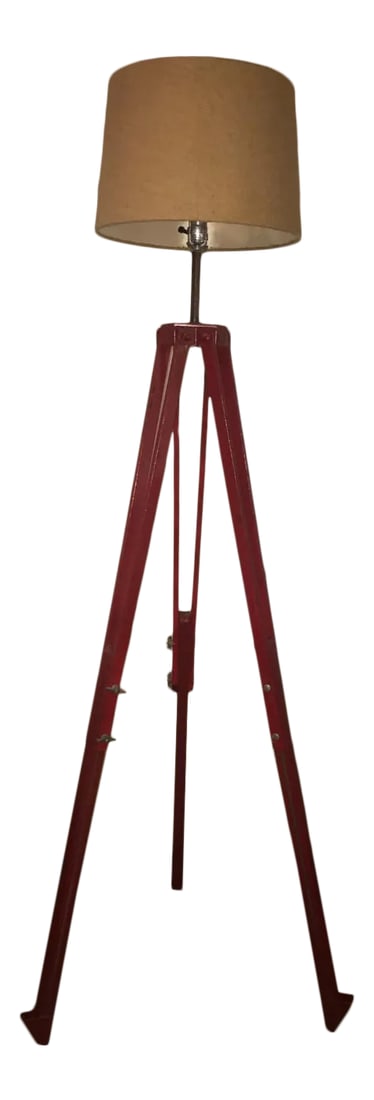 Late 20th Century Repurposed Surveyor's Tripod Floor Lamp: Industrial floor lamp made from a repurposed fire-engine red metal surveyor's tripod. The height (and width of the spokes at the base) are fully adjustable. The pictures show it at a very stable 72" t