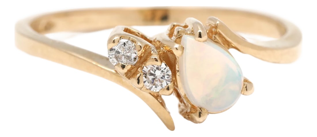 Opal and Diamond Engagement Ring, 14k Yellow Gold, Ring Size 6.5: Stones opal, 1 pear cab 5.6 x 3.9 mm diamond, 2 round brilliant cut 1.9 mm approximately .04 total carats GH color/ SI2-I1 clarity Ring Size 6.5 Rise Off Of Finger: 5 mm Length: 7.5 mm Weight: 1.2 d
