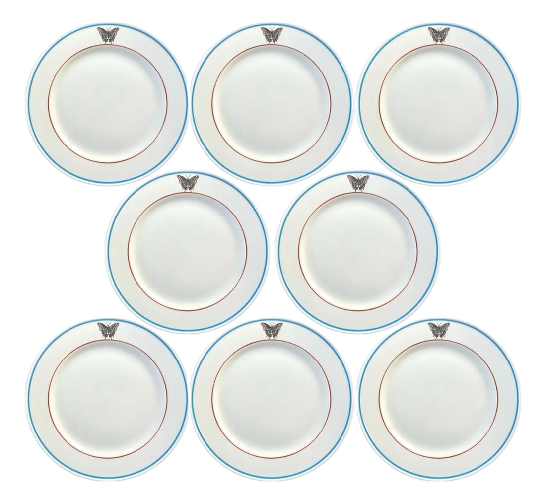 Vintage Lamberton Sterling Butterfly Plates With Banded Details in Orange and Blue, a Set of 8: A charming, rare, set of butterfly plates by Lamberton Sterling. Each features a stylized butterfly motif accented by orange and blue banded details. Stamped "Lamberton Sterling China" to the verso.