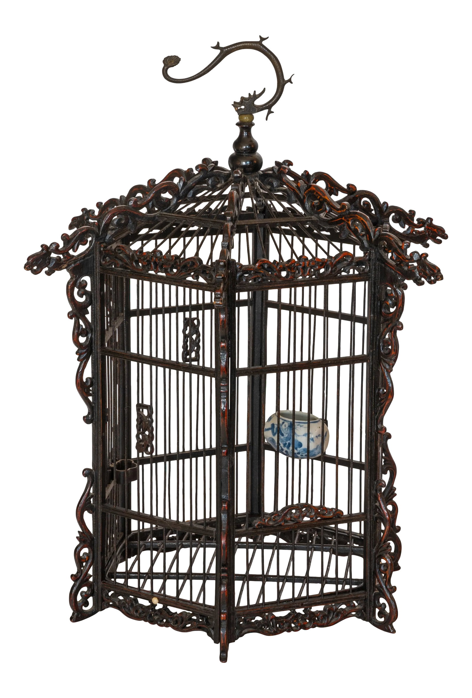 19th Century Asian Pagoda Style Bamboo and Hard Wood Dragon Carved Bird Cage: This late 19th century hexagonal Chinese Wood Carved Birdcage depicts carved dragons on each of the six carved beams supporting the top of the cage and the dragon hook metal handle. The wood dragon