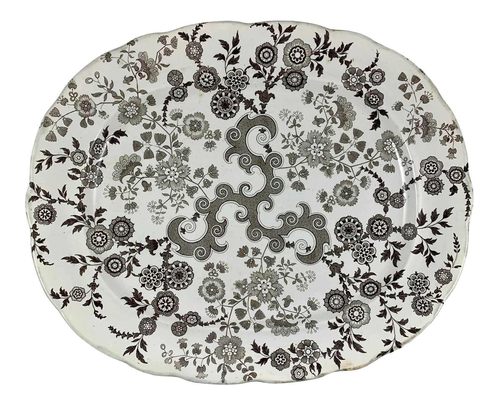 William Ridgway English Staffordshire Transferware Platter, Flosculous Pattern: A black on white transfer printed floral platter in the Flosculous pattern, William Ridgway & Co., Shelton, Hanley, Staffordshire England, circa 1830-1854. A gently scalloped black-printed platter in