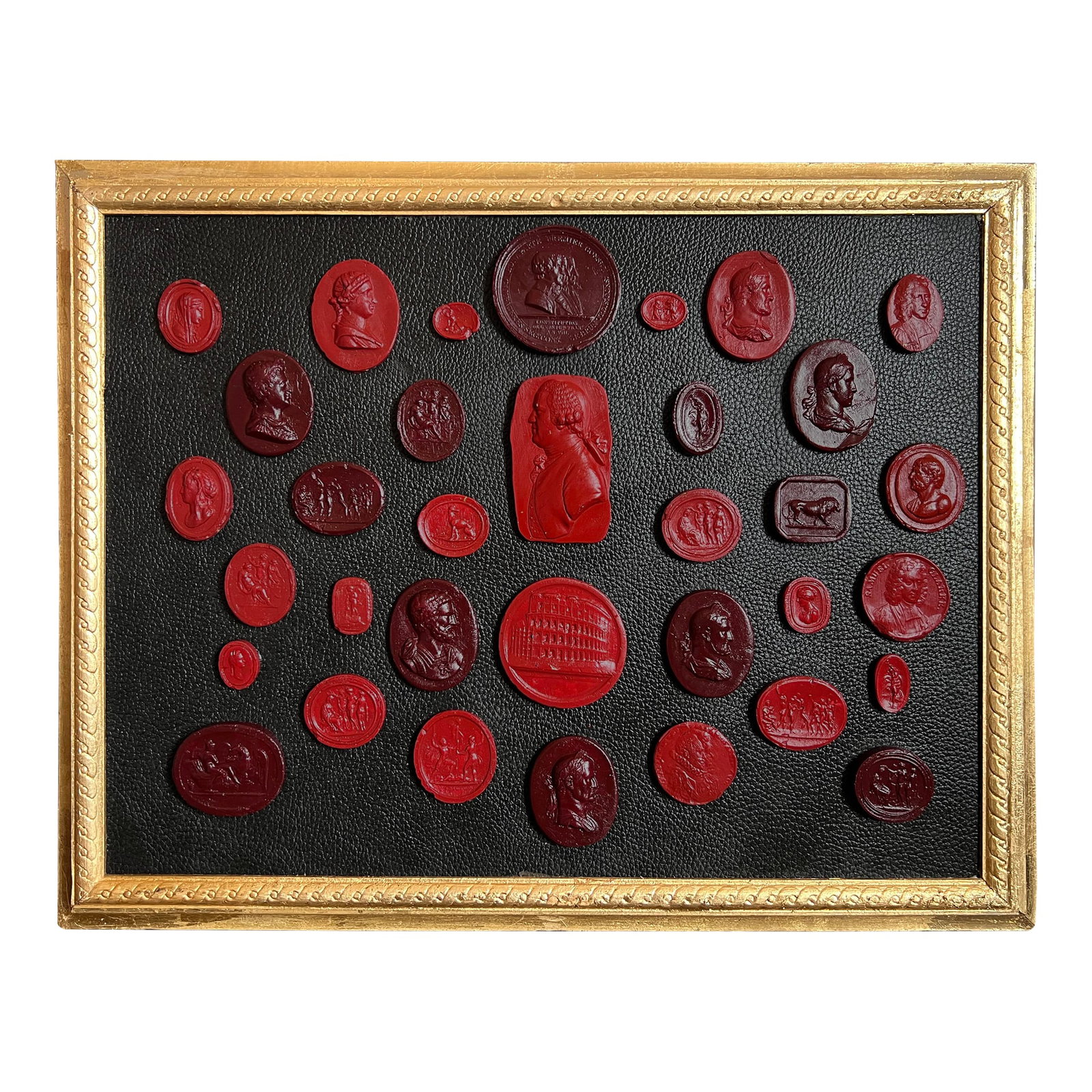 #156 Grand Tour Revival Waxed Red Intaglio Arrangement on the Leather in Gilt Frame: Grand Tour revival Neoclassical waxed red plaster collection of classical Intaglios and Cameos on the Leather Ground With Gilt Frame. The rich character of luxurious antique patina with strong bold