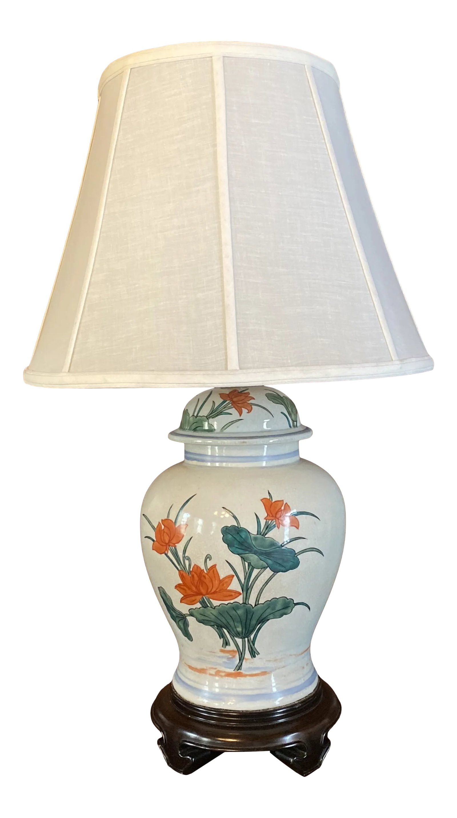 1980s Chinoiserie Ginger Jar Table Lamp: Listing is for a Chinese ginger jar that has been converted to a table lamp. The jar is decorated with a hand painted lily pad and lotus flower design and is mounted on a wooden pedestal. I believe