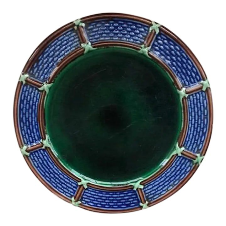 Antique English Wedgewood Majolica Plate: Fine Antique Wedgewood plate featuring a deep green center surrounded by a blue and brown basket weave rim. The back of the plate is impressed with the Wedgewood makers mark and the letters 'VWA'