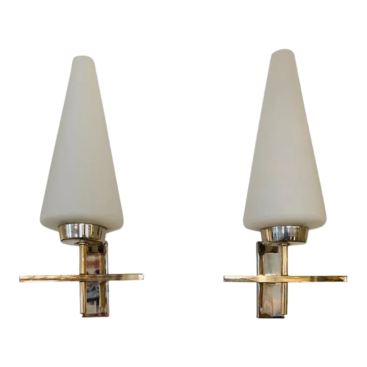 Pair of French 1970s Lunel Wall Lights: An excellent pair of 1970s French brass and polished chrome sconces with white opaline glass cone shades. Rewired. listing is for a pair, a set of two. Condition: Alterations: Restored Imperfections: