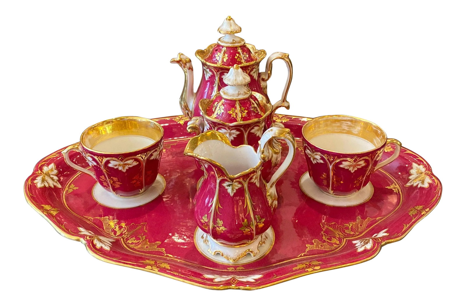 Circa 1875 French Porcelain Tete a Tete Tea Set- 6 Pieces: Elegant 19th century porcelain in white gold and crimson raspberry. The teapot with lid, sugar bowl with lid, creamer, two tea cups with tray. The tray measures 17 wide, 12.75 deep and the small tea