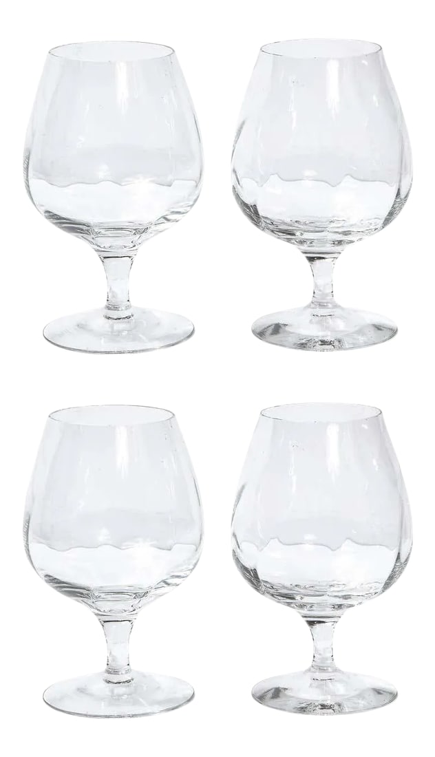 Tiffany & Co. Translucent Crystal Brandy Snifter - Set of 4: This stunning set of four brandy snifters were realized by the fabled American company Tiffany & Co. They feature circular bases; cylindrical stems (that flare slightly at their apex); and rounded