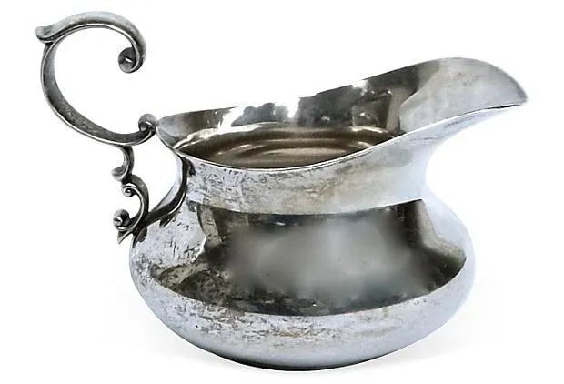 Antique Sterling Silver Creamer: From 1910, this sterling silver creamer has an acanthus leaf shaped handle. There is some tarnish and wear as expected from a sterling silver piece of this age. It is marked "Sterling By Poole, 66"
