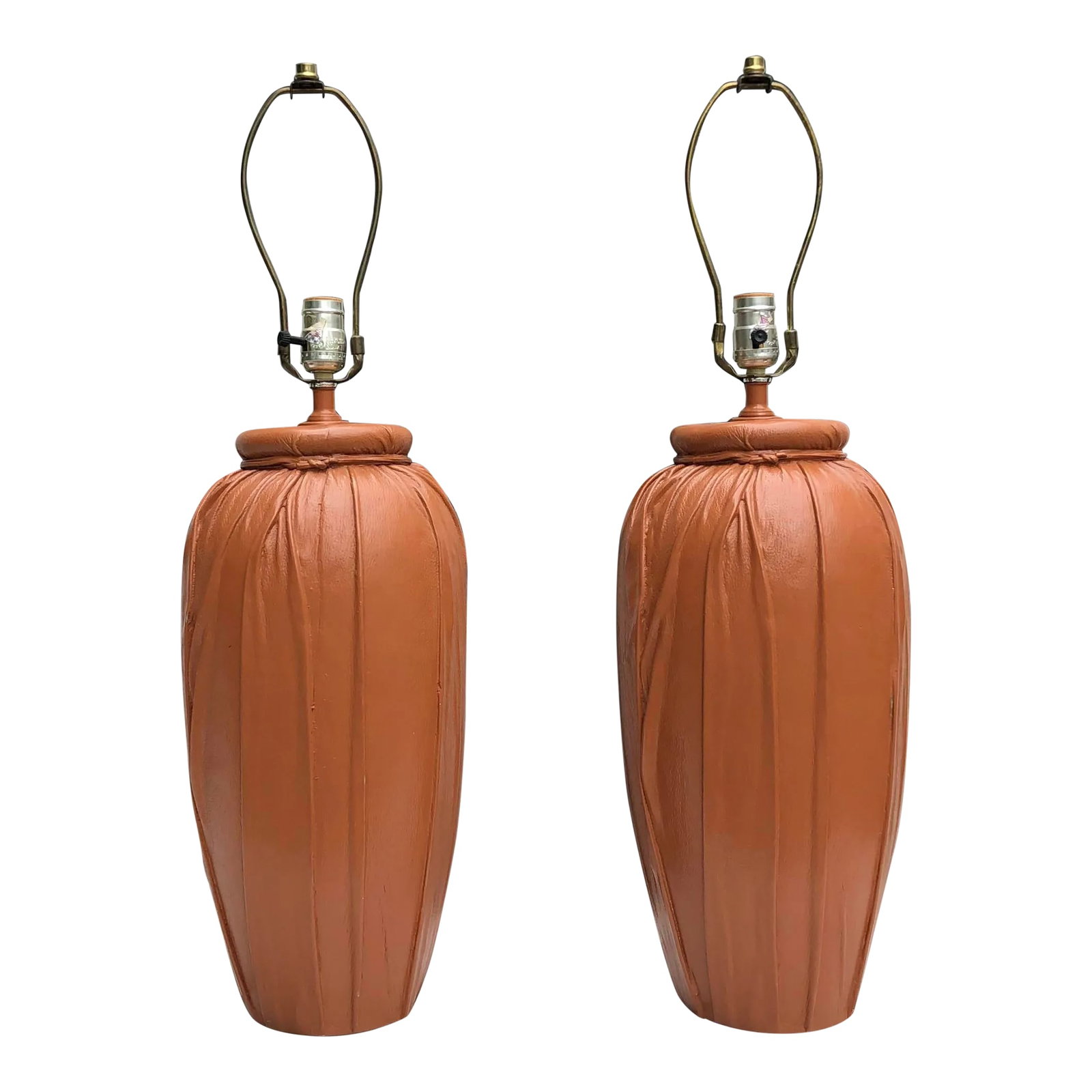 Leather Wrapped Mid-Century Lamps - a Pair: Pair of camel leather wrapped lamps circa mid to late 20th Century. Impactful stature meets a heavy base, finished with a camel leather in full, rich texture and delicate folds. Neck on each is wrappe
