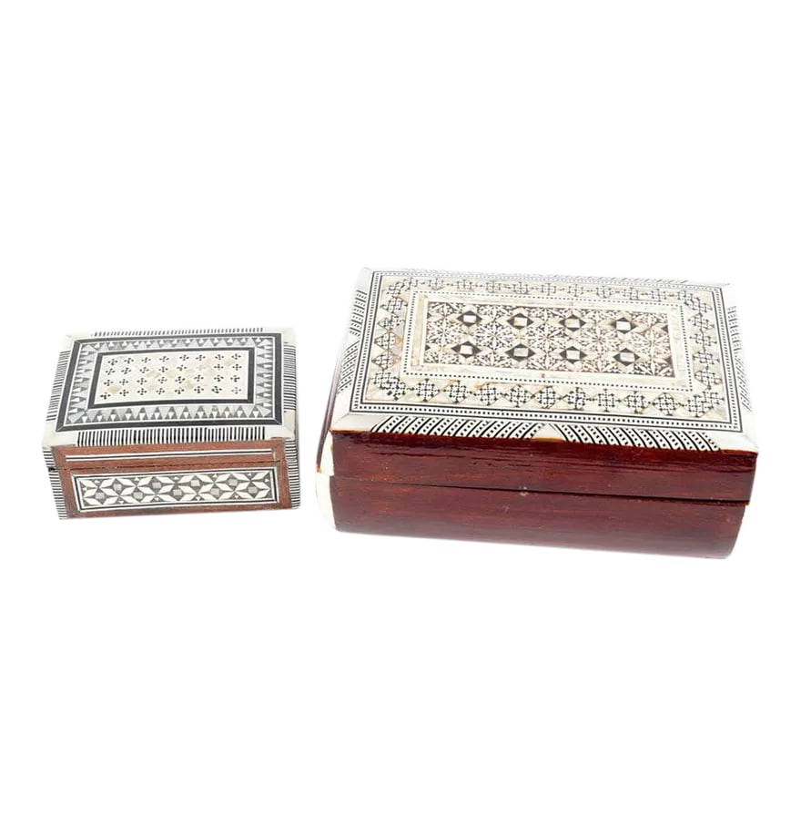 Inlaid Wood Jewelry Boxes - A Pair: A pair of inlaid mother-of-pearl and wood jewelry boxes. The pair includes one larger and one smaller box, both made of wood, with intricate geometric patterns in black stone and mother-of-pearl.