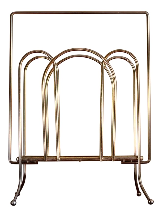 1950s Mid-Century Modern Brass Magazine Rack: A real modernist stunner from the 1950s! This tall, minimal and elegant magazine rack is made of almost entirely brass with a laminate shelf on the bottom. It's the perfect vintage accessory to any