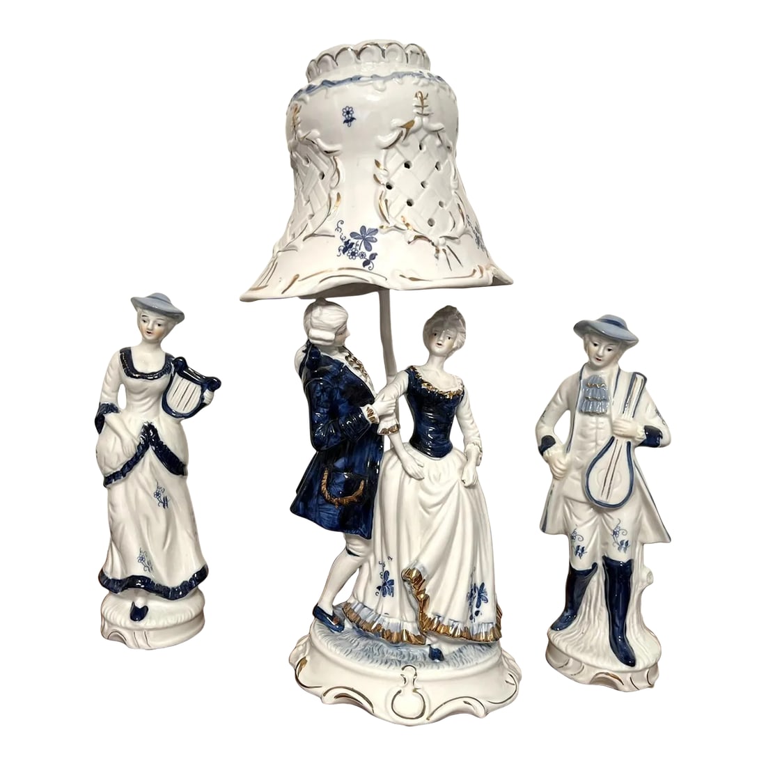Vintage Blue and White Porcelain Figural Lamps With Side Figures - 3 Piece Set: The vintage figural lamp has a group of four figures dressed in 18th century costumes reminiscent of the fashion worn by the nobility of the French Court. The couple under the lamp was dancing to the 
