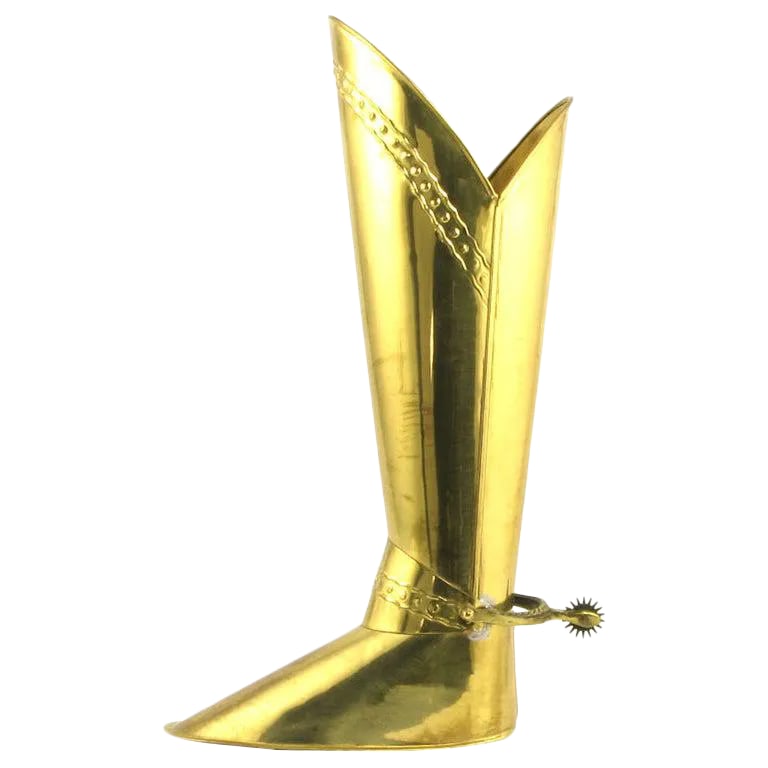 English Spurred Brass Knight's Boot Umbrella Stand: Brass umbrella holder in the form of a riding boot, with stamped brass detail and solid brass spur. Heavily weighted for stability. Stamped "Made in England." Condition: Alterations: Original Conditio