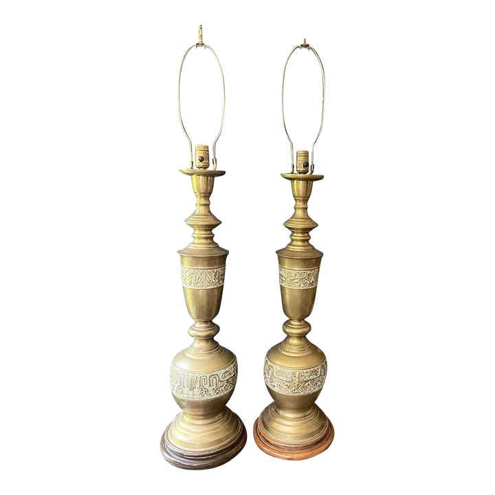 Mid Century Tall James Mont Style Brass Table Lamps - a Pair: Stunning pair of tall, brass table lamps presented in James Mont style, each lap rests upon a round would Asian influenced base. They sculpt upward with panels of Asian influenced design that has a