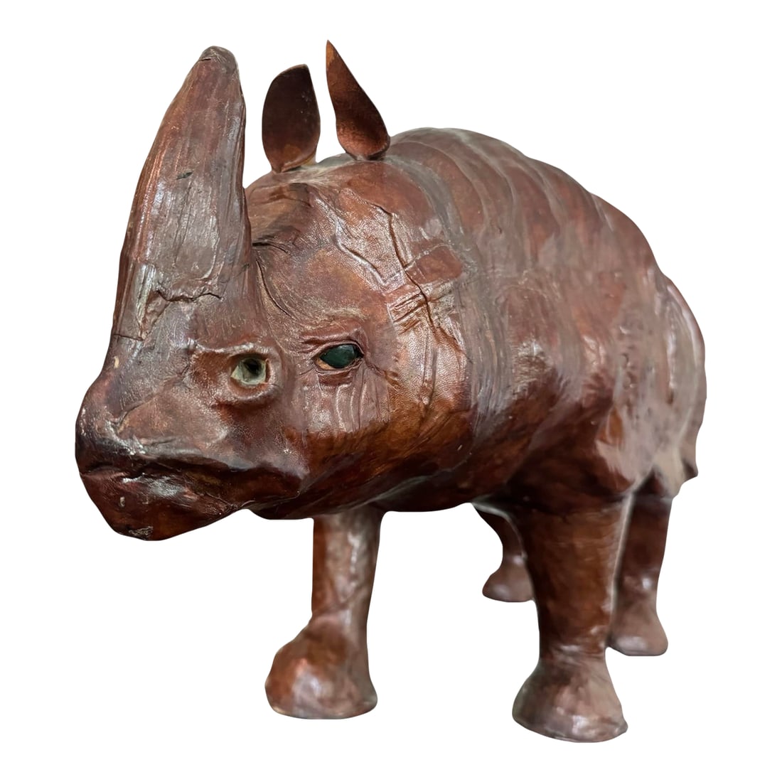 Vintage Mid Century Modern Leather Rhinoceros With Glass Eyes Rhino Sculpture: Introducing a magnificent addition to your home decor: our Large Vintage Leather Wrapped Rhino Sculpture. This extraordinary piece showcases the perfect blend of artistry and craftsmanship, capturing