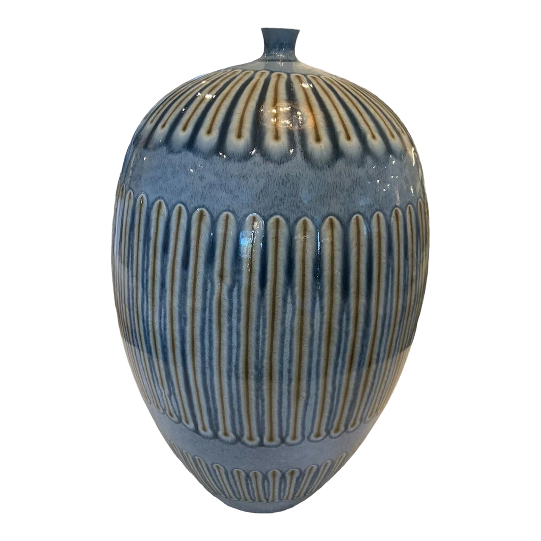 Blue Grande Bottle Vase: Elegant shape is hand decorated expressing a look reminiscent of studio pottery of the 1960's. The unique pattern is hand drawn using a combination of crayon and glaze by European artisans. Each
