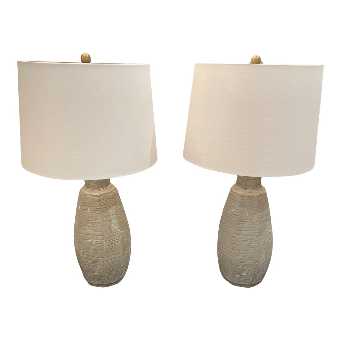 Pair of Gray Lamps: Brighten your space with this elegant pair of gray textured lamps. Each lamp features a sophisticated gray hue with a subtly textured finish, adding depth and interest to any room. Their versatile