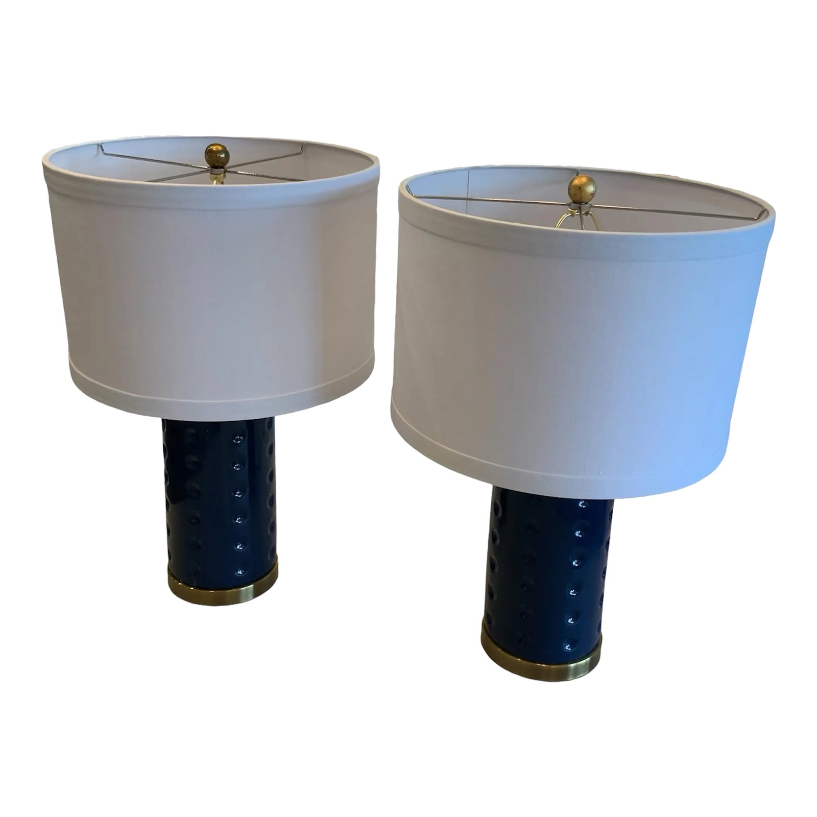 Pair of Roxanne Blue Dot Lamps: This blue Roxanne Table Lamp brings a bold touch of color to contemporary interiors. Its cylindrical ceramic base is adorned with recessed dots and accented with bronze fittings with a contrasting