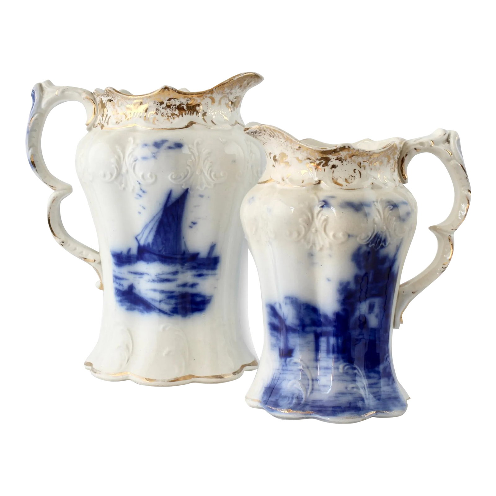 Late 19th Century English Flow Blue Nautical Jugs- Set of 2: Pair of antique matching English flow blue pitchers featuring a charming harbor scene and a windmill (reminiscent of Dutch Delft patterns). These beautifully detailed pitchers showcase the classic