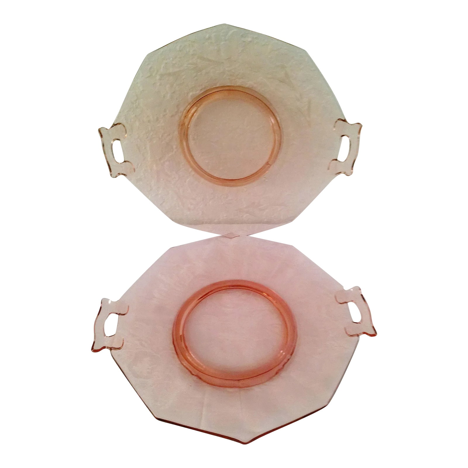 Mid-Century Pink Depression Glass Serving Platters, a Pair: Pretty pair of 1950s pink depression glass platters with double-handles. Set consists of one clear glass platter and one etched glass platter featuring a delicate floral design around perimeter.