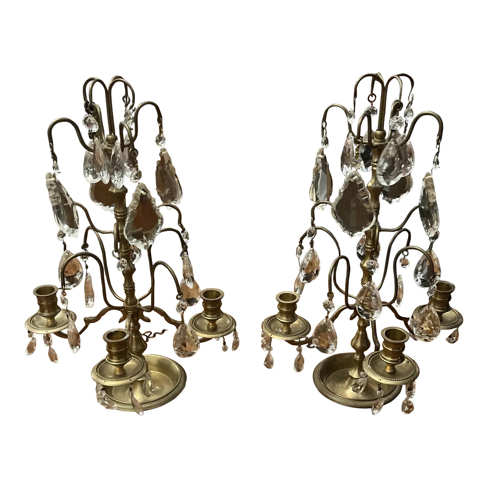 Pair of French Brass and Crystal Girandoles: Pair of French Brass and crystal Girandole candelabra, each with three candle cups, making them the perfect addition to a mantle or chest. Condition: Alterations: Original Condition Unaltered