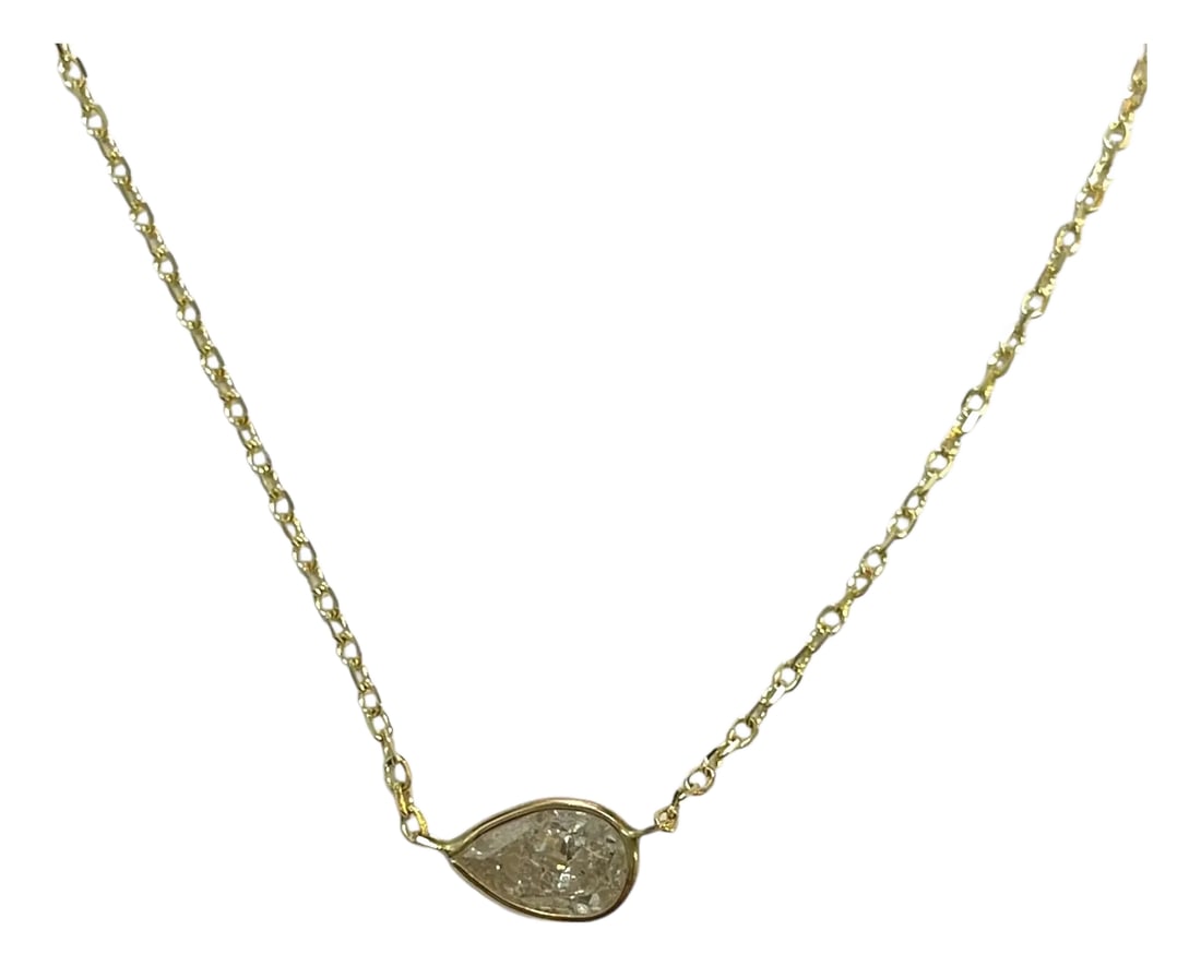 14k Yellow Gold 0.76ct Pear Natural Diamond Bezelled Necklace: This charming piece boasts a 0.76ct pear-cut natural diamond in a refined 14K yellow gold bezel setting. Its understated beauty and adjustable chain make it a must-have for the modern jewelry lover