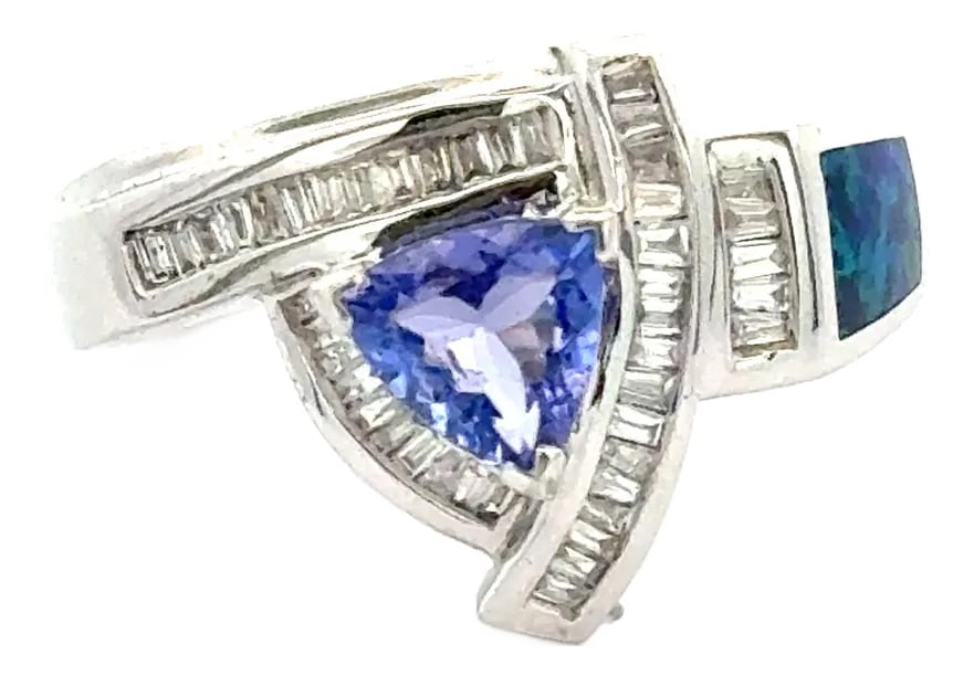 Vintage Tanzanite Inlaid Opal and Diamond Cluster Ring in 14k White Gold: Vintage Natural Tanzanite, Inlaid Opal, and Diamond Cluster Ring in 14K Solid White Gold. Prong and tension set. Details: Tanzanite: 0.55 Carats, Trillion cut Diamond: 0.35 Carats, Baguette Cut Opal: