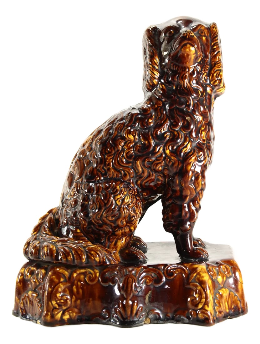 19th Century Rockingham Glaze Yellowware Dog King Charles Spaniel: An amazing yellowware Rockingham glaze dog figure What is known as Rockingham pottery began in England and is characterized by its mottled brown surface. When English potterers began immigrating to