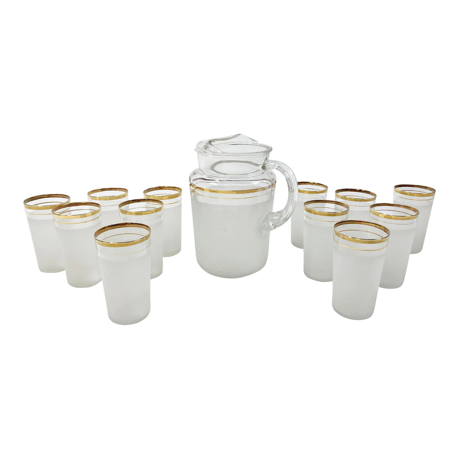 Vintage Etched Glass Gold Rimmed Pitcher and 12 Glasses, Set of 13: Vintage Mid-Century Modern pitcher and glassware set featuring large pitcher and 12 matching juice glasses. Each has gold rim and stripe to top with white etched body to lower half. A uniquely large