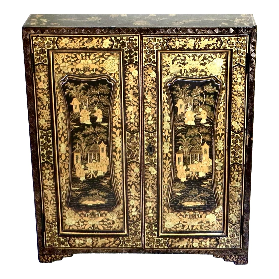 19th Century Chinese Export Table Top Black Lacquer Jewelry/Valuables Cabinet: Chinoiserie hand painted 19th century Chinese export jewelry cabinet circa 1880; is fronted by a pair of raised panel double doors; decorated in gilt with scenes of Chinese figures, floral borders,