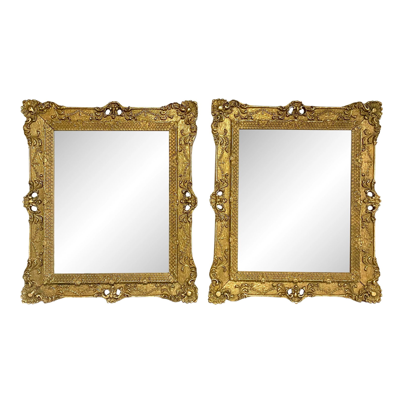 Early 20th Century Ornate Gilded Regency Mirrors- Set of 2: These stunning Regency style mirrors boast elegant proportions and intricate details, their gilt frames adorned with delicate floral motifs and subtle scrollwork. The mirrored glass reflect the