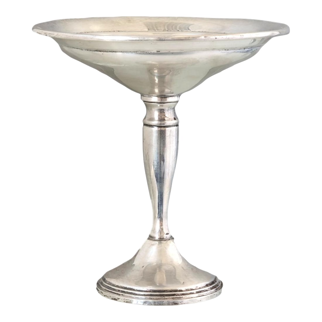 Mid 20th Century Sterling Silver Footed Compote: Sterling silver compote by Reed & Barton, marked on the base. With its tall profile, gracefully turned stem, and flared bowl, this piece embodies mid-century elegance and functional design. Perfect