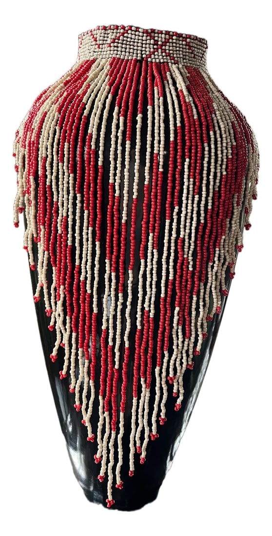 1990s Vintage Maasai-Style Beaded Tribal Bib Necklace: Striking Maasai-style beaded necklace featuring an intricate pattern of cascading red and ivory glass seed beads. Handwoven by artisans in Kenya, this piece exemplifies traditional East African