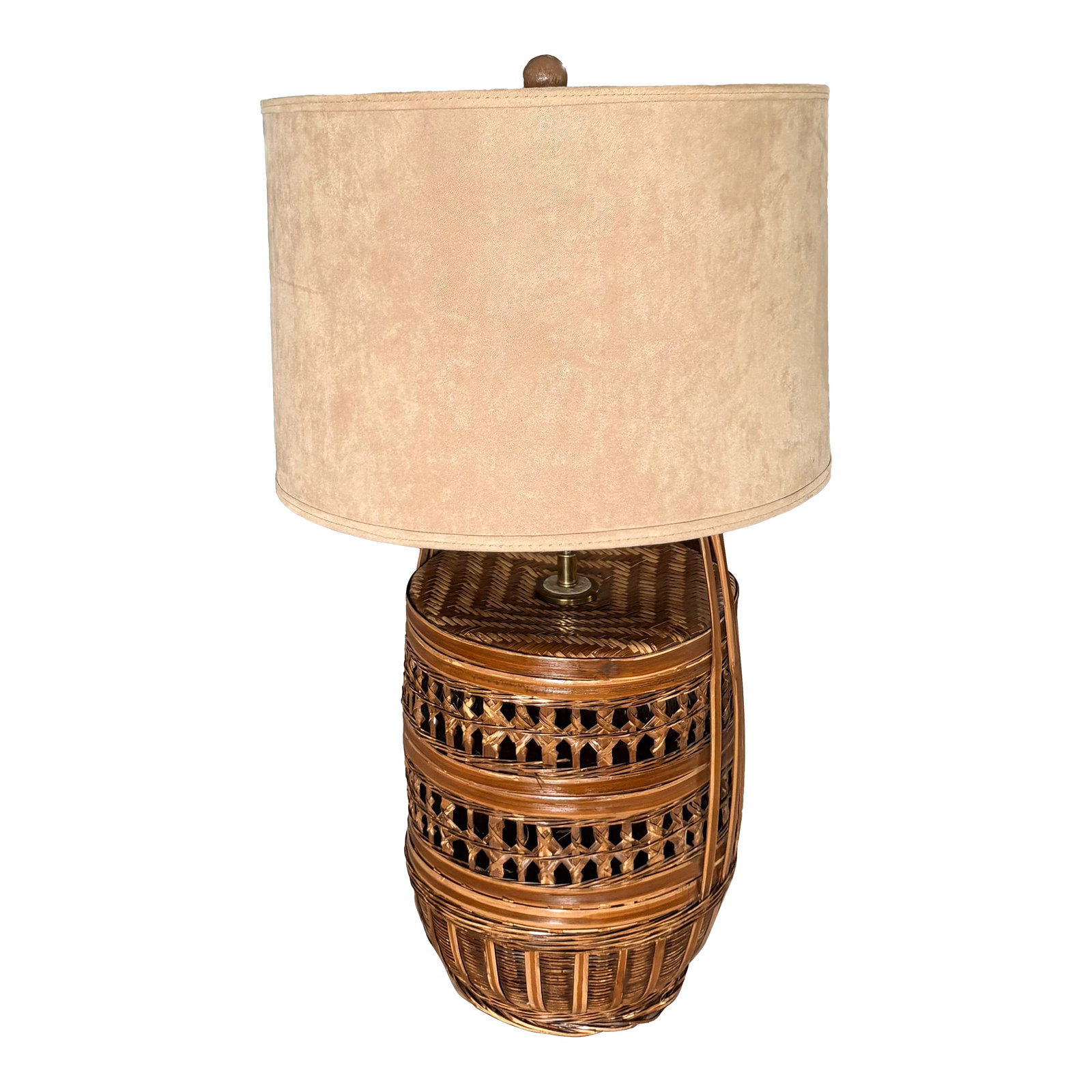 Vintage Coastal Woven Rattan Table Lamp With Sueded Shade: This vintage woven rattan table lamp features a rounded aged rattan base finished with a warm honey stain accentuated brass finishes and a custom ceramic ball finial. The round drum shade us a beige