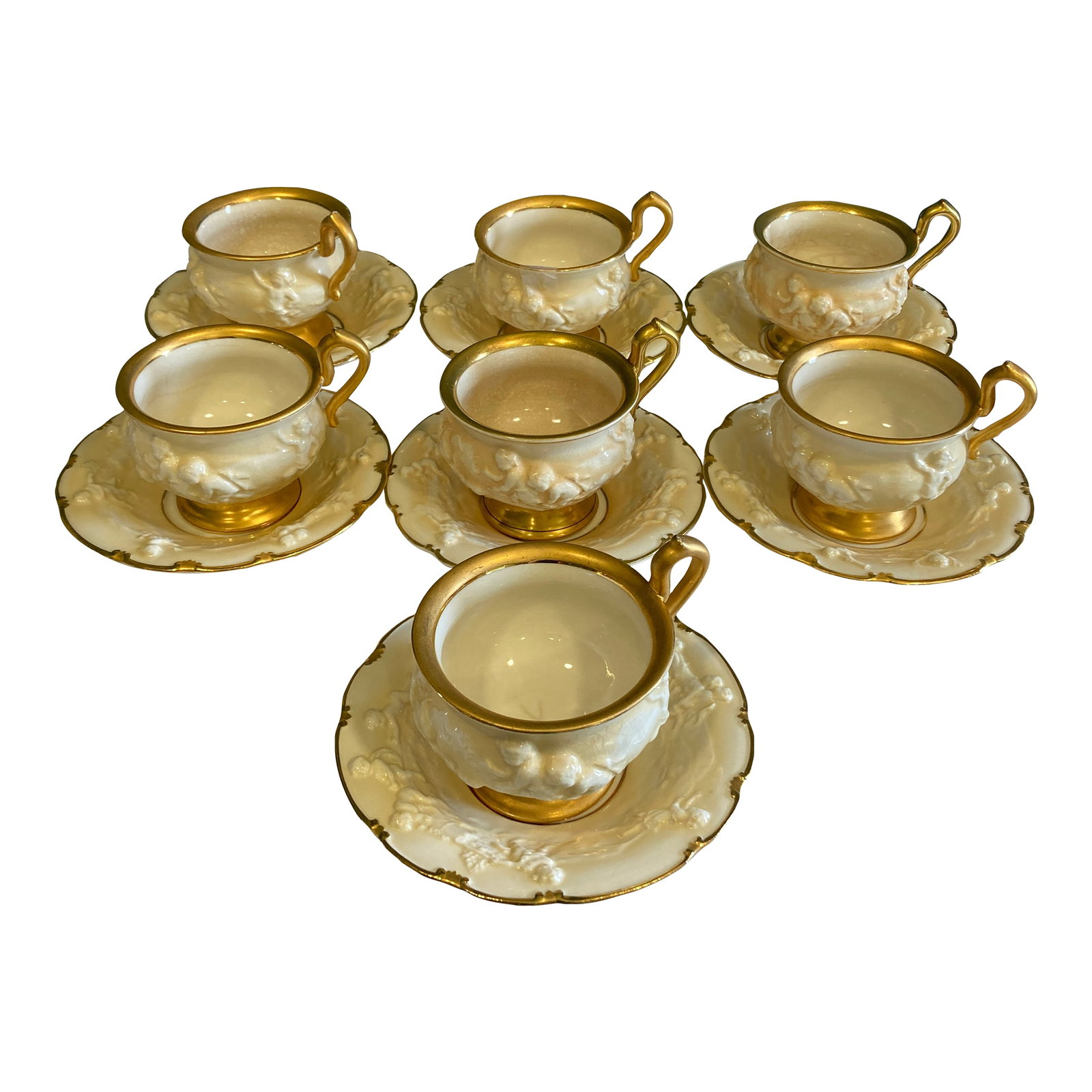 Antique Ernst Bohne Sohne Cherub Teacup and Saucer With Gold Trim Set- 14 Pieces: This elegant set of 6 teacups and saucers by Ernst Bohne Sohne of Germany showcases exquisite 19th-century porcelain craftsmanship. Each piece features delicately raised floral patterns, a creamy ivor