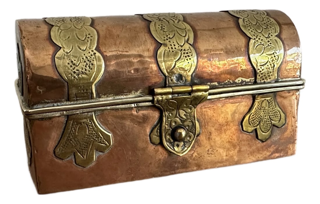 Antique Betel Decorative Treasure Box: This striking antique betel box features a beautifully aged copper body accented with repousse brass mounts, forming a domed, chest-like silhouette rich in texture and history. Traditionally used