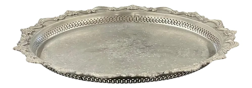 Early 21st Century Moroccan Silver Tray - Medium: This stunning silver tray from Morocco is handcrafted and embossed with an arabesque design throughout the tray. The intricate details and ornate raised motifs on the surrounding edges make this tray