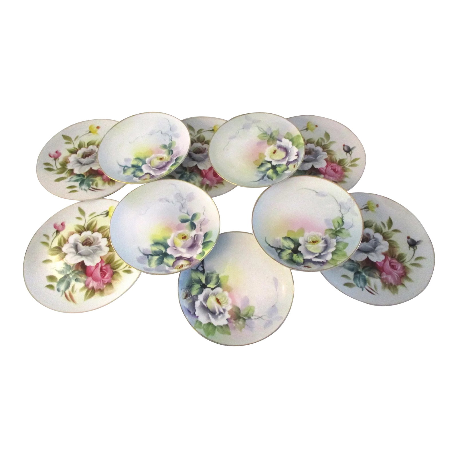 Mid-Century Japanese Hand-Painted Floral Plates, S/10: Pretty set of ten Japanese hand-painted floral porcelain dessert plates. Dimensions: pink and white plates, 7.25"Dia x .75"H; lavender and white plates, 6.5"Dia x .75"H. Excellent condition.