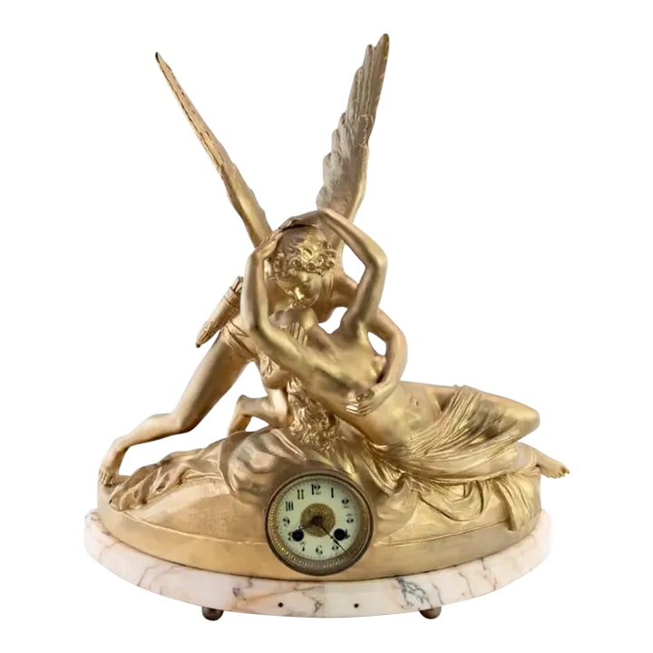 1930s Vintage French Figural Spelter Clock: This vintage French spelter clock with gold finish depicts Psyche being awakened by Eros' kiss. It is entitled "Amour et Psyche" and is copied from the original in the Louvre, Paris. The clock was