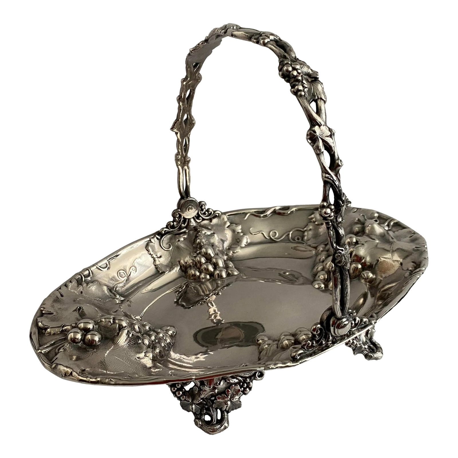 Antique Silverplate Grape Vine and Leaf Basket: 1910s silver plate basket by Homan Manufacturing Company. Impressed grape clusters or bunches in the well and lip of the basket with a grapevine form handle. There is an engraving medallion at the top