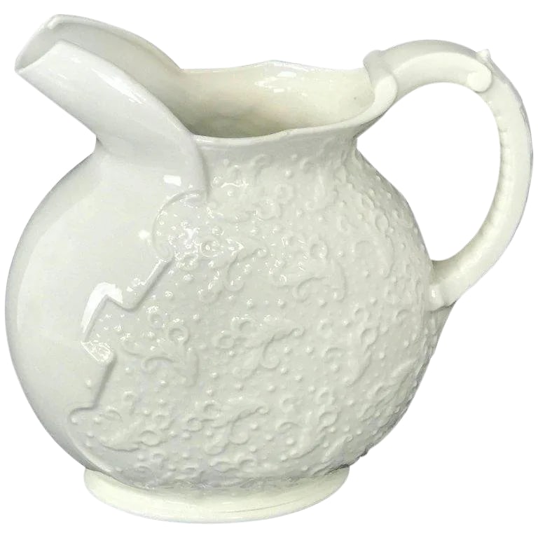 Late 19th Century Ott & Brewer Aesthetic Blanc De Chine Pitcher: Ott & Brewer aesthetic blanc de chine pitcher, with patterned body and reptile handle. Stamped O & B. Condition: Alterations: Original Condition Unaltered Imperfections: Some Imperfections Condition