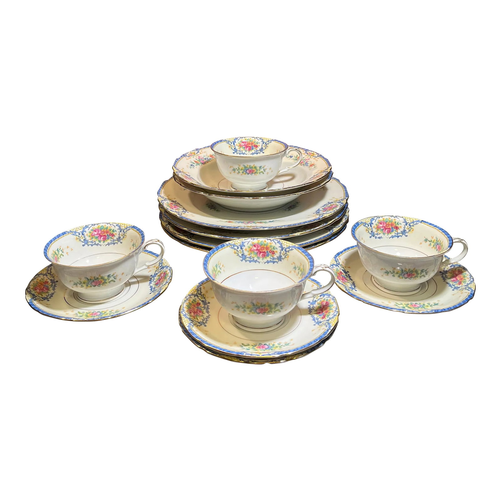 14 Piece-Early 20th Century Rhoda Rhoda Blue by Black Knight Dinnerware Set, Germany: Off-white background with scroll and floral patterns highlighted in gold. Scalloped edge. (4) Dinner plates- 10" x 10" (4) Cups- 4.75" x 4" (4) Saucers- 6" x 6" (2) Rim soup bowls- 8.25" x 8.25" Condi