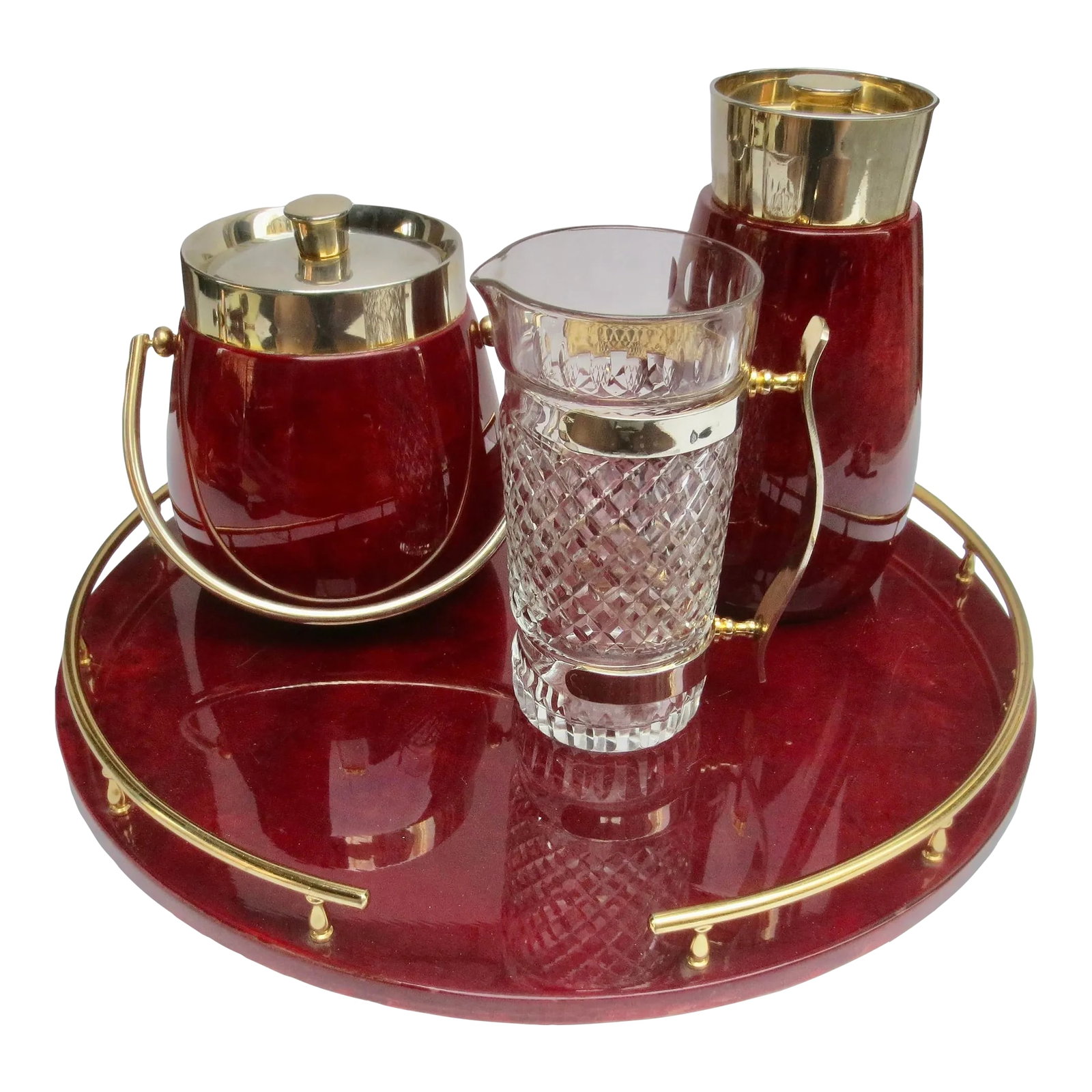 Aldo Tura Bar Set Lacquered Goat Skin -Set of 4: Aldo Tura bar set circa 60s'-70s'. Four pieces of burgundy color serving tray, ice bucket, Cocktail shaker, and a pouring pitcher. The shaker has an inner brass liner with a strainer lid and closing c