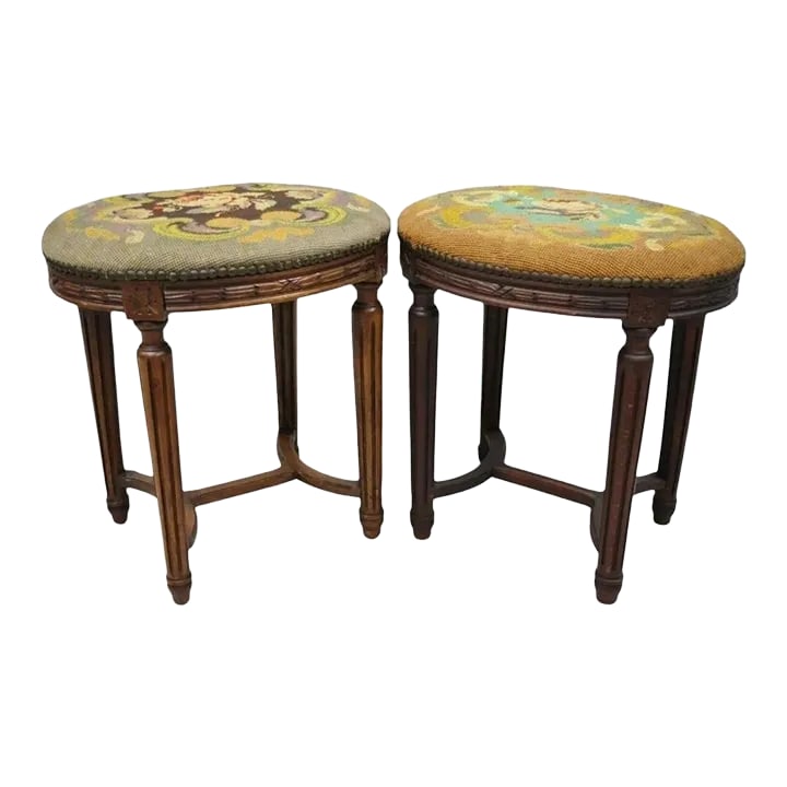 Early 20th Century Antique French Louis XVI Style Carved Walnut & Needlepoint Oval Stools - a Pair: Pair of Antique French Louis XVI Style Carved Walnut & Needlepoint Oval Stools. Item features floral needlepoint upholstery, remnants of label, solid wood frame, beautiful wood grain, tapered legs, ve