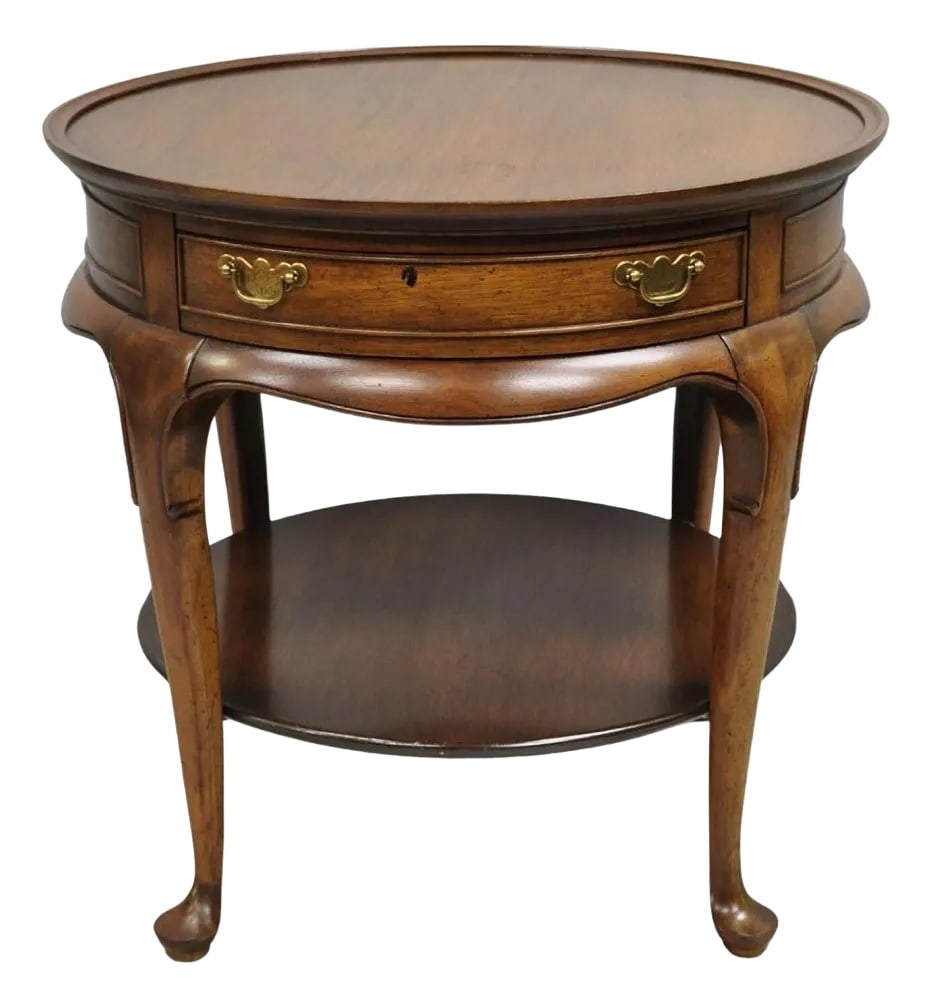 Vintage English Queen Anne Style Round Walnut Wood Lamp Side Table by Hekman: Vintage English Queen Anne Style Solid Round Walnut Wood Lamp Side Table with Single Dovetailed Drawer by Hekman. Circa Late 20th Century. Measurements: 24.5" H x 26" W x 26" D. Condition:
