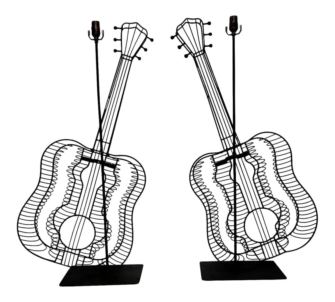 Mid 20th Century Fredrick Weinberg Style Guitar Lamps - a Pair: A pair of Fredrick Weinberg Style guitar lamps, one facing right the other facing left. The actual sculptures measure 38 inches high x 4 inches deep. Condition: Alterations: Restored Imperfections: