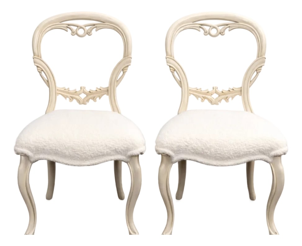 Pair of French-Style Dining Chairs With Carved Backs and White Boucle Upholstery: The gracefully curved frames showcase refined detailing and a timeless silhouette inspired by traditional French design. The seats have been newly upholstered in luxurious white boucle, offering a