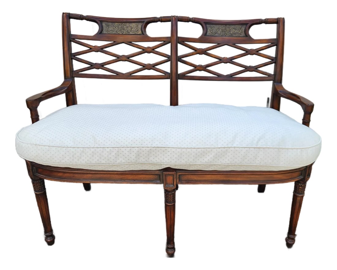 Vintage Regency Style Faux Bamboo Cane Settee With Reversible Down Cushion: A handsome vintage double-chair-back settee in the Regency Revival taste, featuring a warm mahogany-tone wood frame, elegant lattice backs, decorative metal accent plaques, and a beautifully preserved