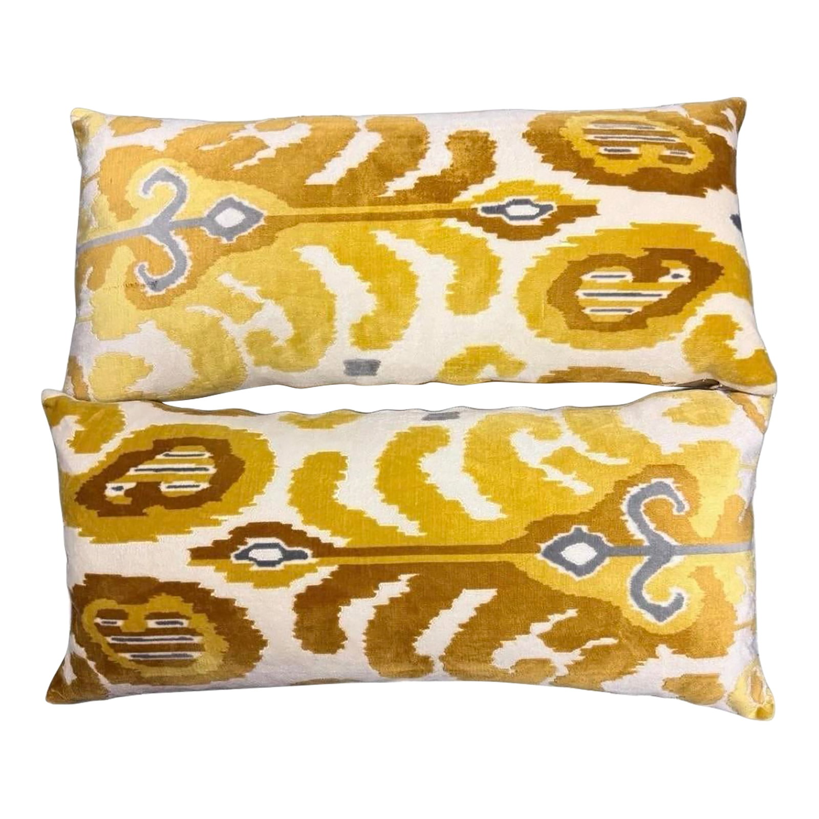 Velour Velvet Ikat Lumbar Pillows - A Pair: These decorative throw pillows feature a vibrant yellow ikat pattern on one side and a solid mustard yellow velvet fabric on the reverse. Measuring approximately 26 inches in length and 10 inches in w
