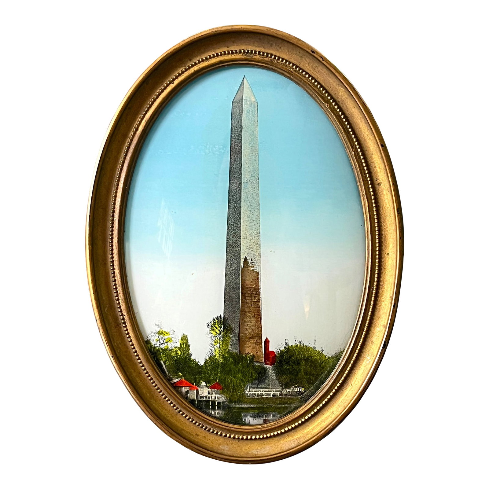 Antique Reverse-Painted Washington Monument Glass Plaque in Oval Brass Frame, Circa 1900: A charming turn-of-the-century reverse-painted glass depiction of the Washington Monument, housed in its original oval brass easel frame. Rendered with remarkable detail, the image captures the